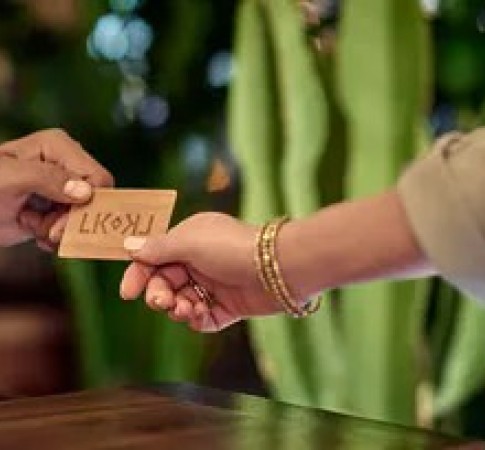 a person handing a card to another person